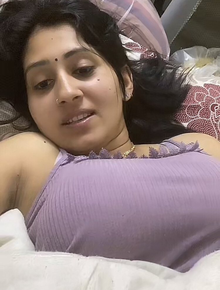 Indian bhabhi in purple saree lying seductively in bedroom