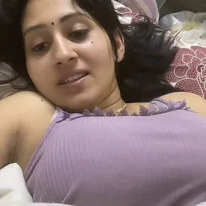 Indian bhabhi in purple saree lying seductively in bedroom