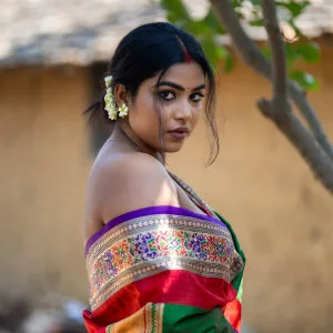 Beautiful Indian woman in traditional saree posing gracefully outdoors