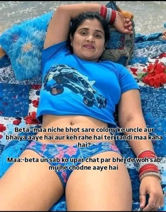 Indian aunty relaxing on floral blanket at beach wearing blue top and shorts