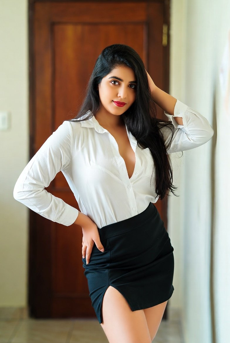 Desi bhabhi in white blouse black skirt posing confidently