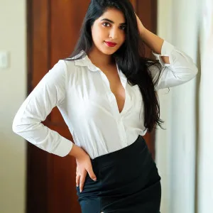 Desi bhabhi in white blouse black skirt posing confidently
