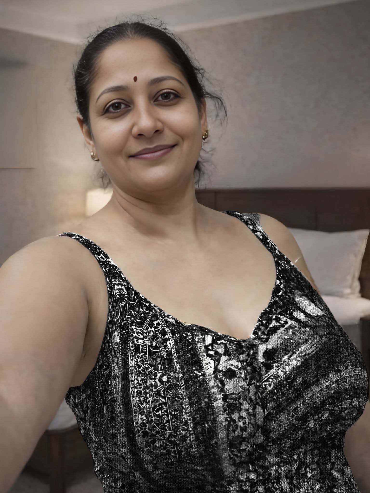 Indian aunty in glamorous black outfit looks sultry