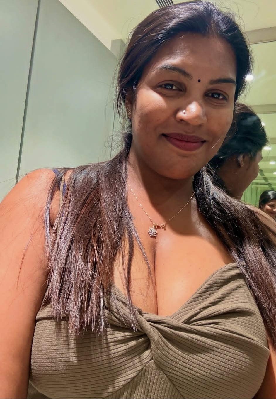 Desi woman in twist front top smiling and captivating