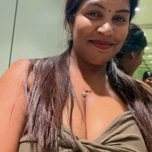 Desi woman in twist front top smiling and captivating