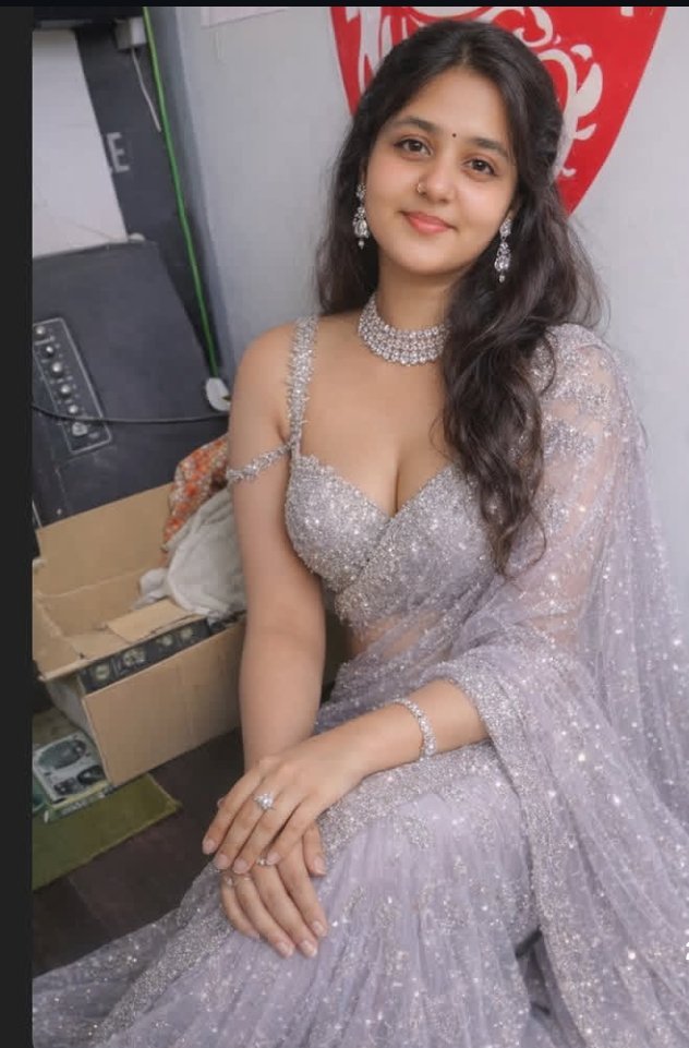 Indian woman in silver lehenga with jewelry smiling