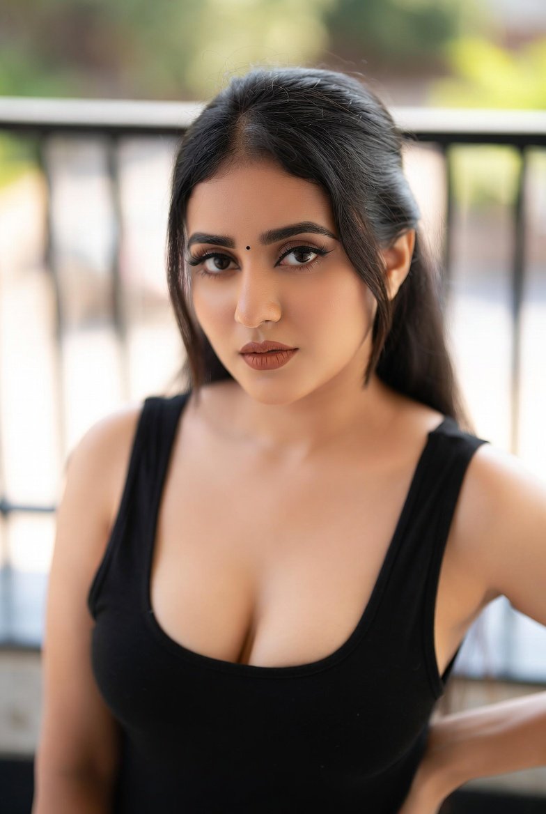 Indian woman in black top with a stunning bust