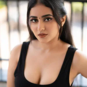Indian woman in black top with a stunning bust