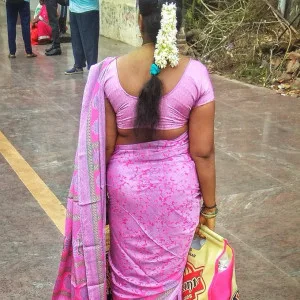 Desi aunt in pink saree standing outdoors