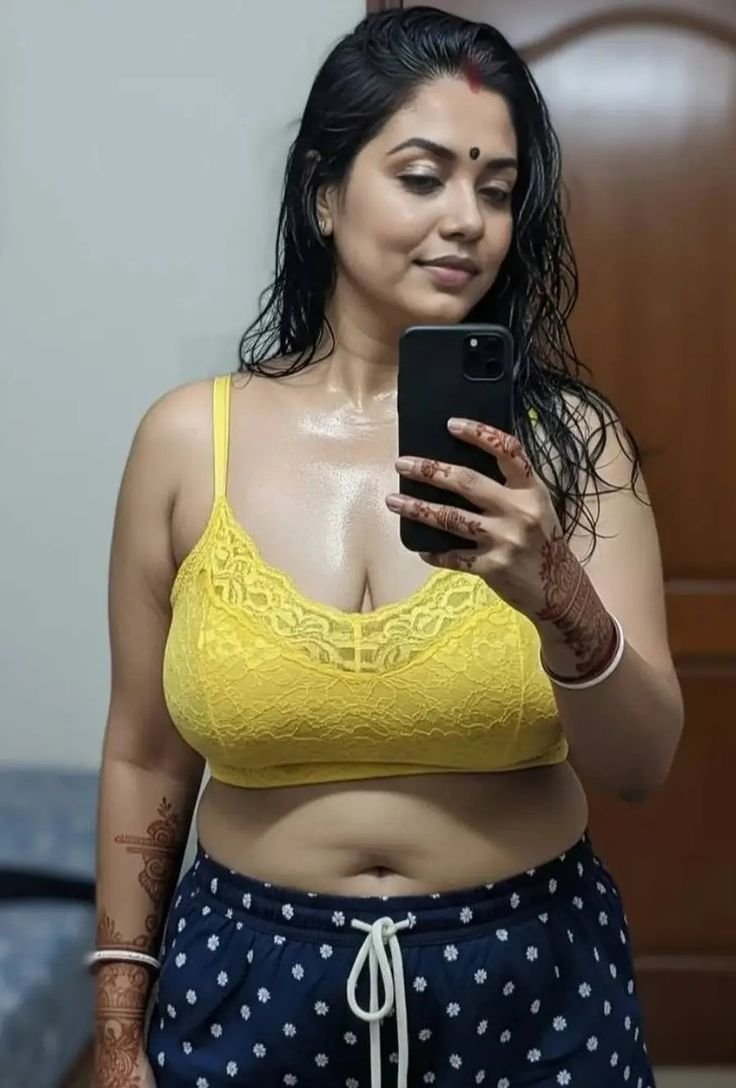 Sensuous Indian bhabhi taking selfie in yellow bra and blue shorts