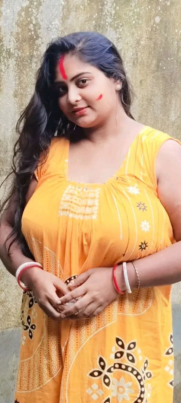 Beautiful Indian bhabhi wearing vibrant yellow salwar, embracing her cellulite