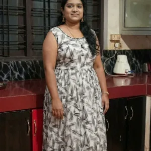 Curvy Indian bhabhi in maxi dress standing in a kitchen