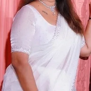 Desi aunty in white saree smiling gracefully