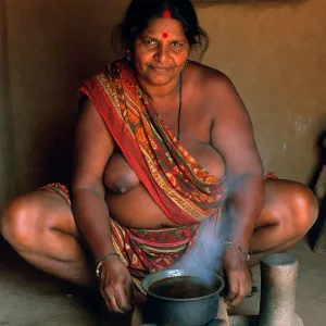 Curvy Indian bhabhi cooking while wearing a revealing saree