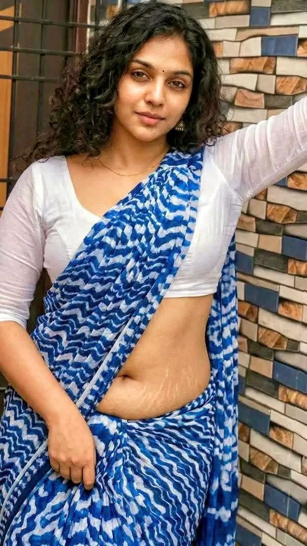 Curvy South Indian aunty in blue white saree posing confidently