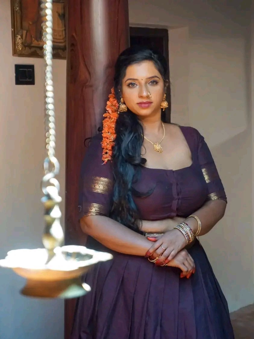 Exotic Indian bhabhi in purple saree with traditional jewelry