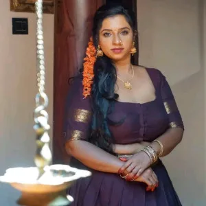 Exotic Indian bhabhi in purple saree with traditional jewelry