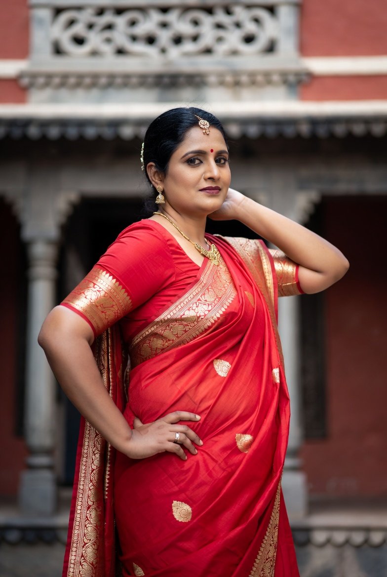 Beautiful Indian aunty in red saree posing confidently