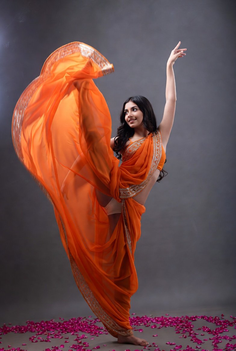 Gorgeous Indian bhabhi in orange saree posing seductively among rose petals