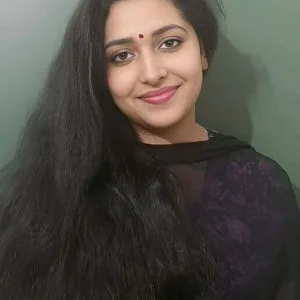 Beautiful Indian girl with long dark hair and bindi posing in black traditional outfit