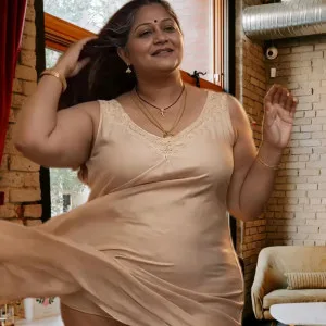 Sexy Indian bhabhi in beige dress posing at home