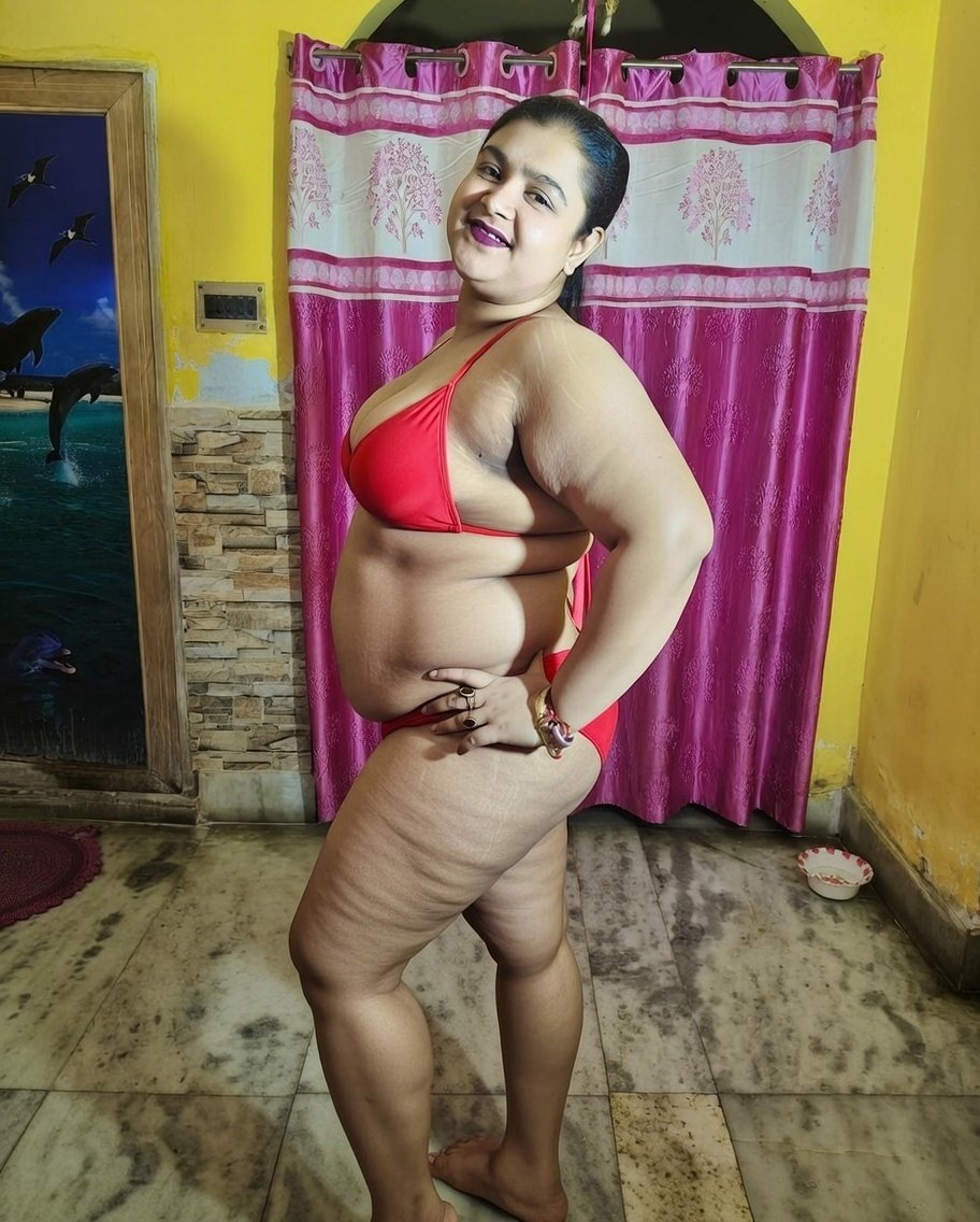 Confident Indian bhabhi in red bikini showing curves indoors