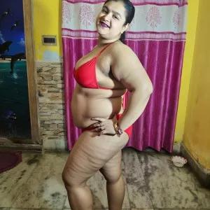 Confident Indian bhabhi in red bikini showing curves indoors