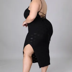 Curvy Indian aunty in black dress posing confidently in studio